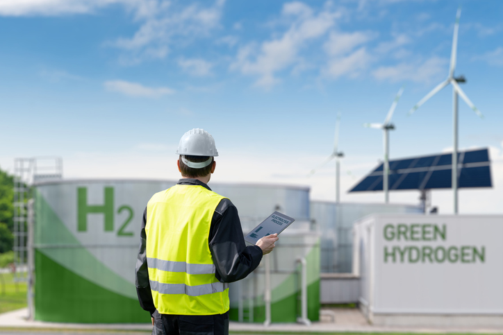 Engineer inspecting green hydrogen storage tanks